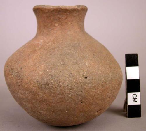 Water worn plain pottery jar with sub-globular body and constricted neck