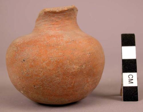 Smal plain orange pottery jar - handle broken off.