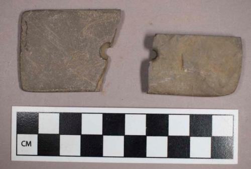 Ground stone, square and polished fragments, broken at perforation