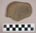 Ground stone, modified lithic with flat side and smoothed edges