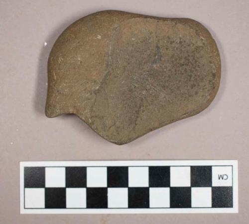 Ground stone, modified lithic with flat side and smoothed edges