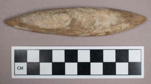 Ground stone, modified lithic, flattened, elongated shape terminating in points on each side