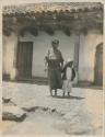 Woman and boy standing in front of a building