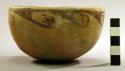 Ceramic bowl, red-on-buff interior & exterior, fire clouded, chipped rim