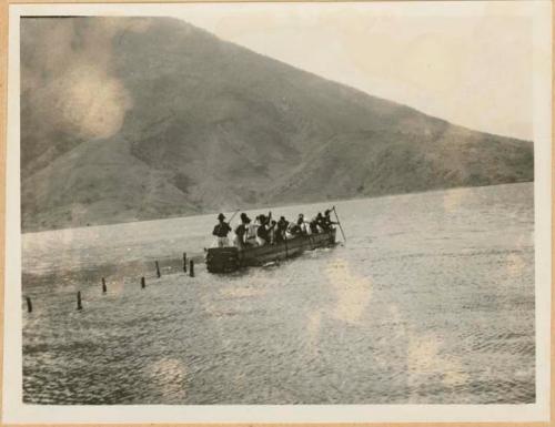 Group of people in boat on lake