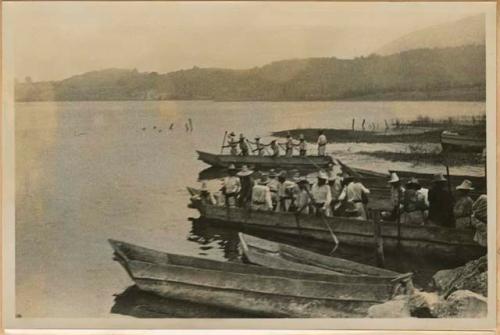 Men in boats along shore