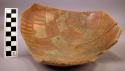 Two-thirds of decorated pottery bowl containing corn