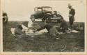 Rossbach, Eleanor Lothrop and Atwood picnicking in front of expedition vehicle