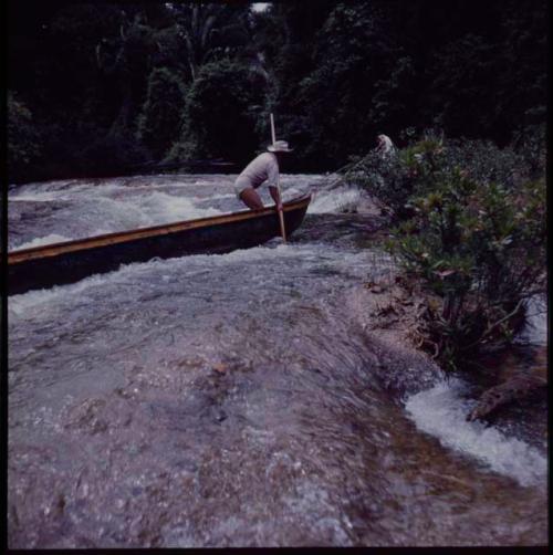 Man poling boat on Machaquila River