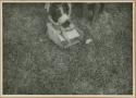 Ngobe-Bugle child sitting on box holding Fine Old Whisky Rye bottle