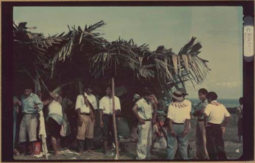 Ngobe-Bugle site at mouth of the Cricamola River, crowd standing under thatch-roofed canopy