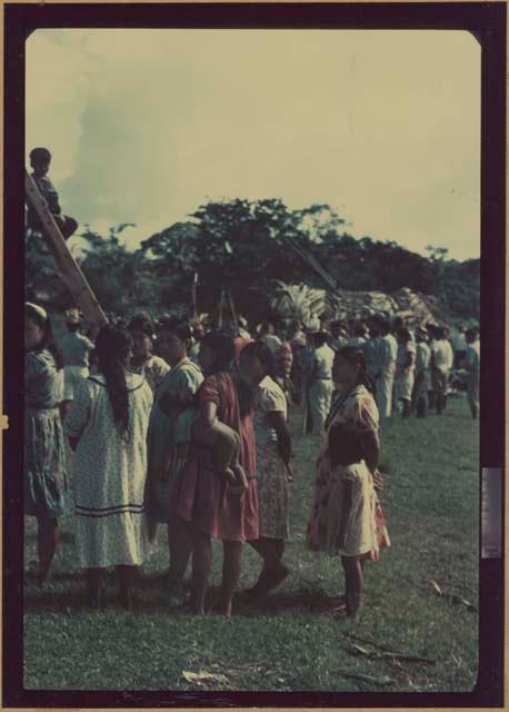 Ngobe-Bugle site at mouth of the Cricamola River, busy crowd, boy sitting on ladder left frame