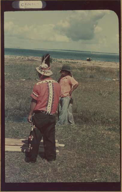 Ngobe-Bugle men at mouth of the Cricamola River, balsa poles on ground