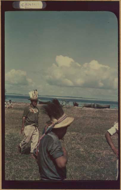 Ngobe-Bugle men in feathered hats at mouth of the Cricamola River