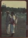 Ngobe-Bugle crowd, man in front has unknown animal on back