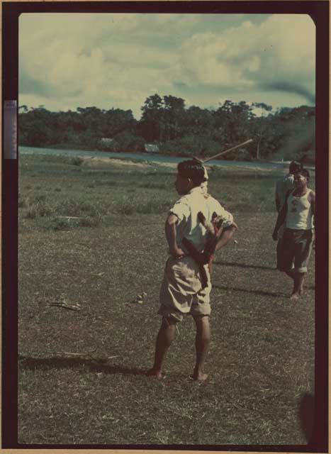 Ngobe-Bugle crowd next to Cricamola River, man with unknown animal on back