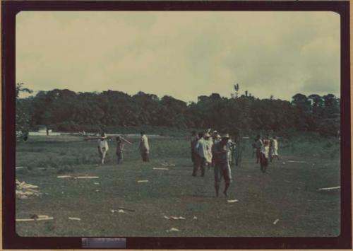 Ngobe-Bugle crowd in field, broken balsa poles on ground, during Balseria