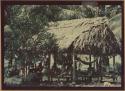 Ngobe-Bugle group laying under thatch-roofed canopy