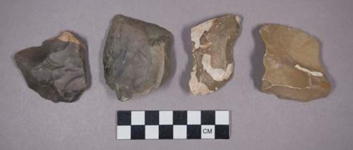 Flint scrapers, unifacial points, flakes, and a brick fragment