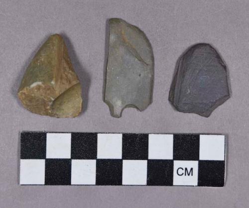 Ground stone and perforated stone fragments, one burnished and one abraded