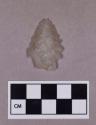 Chipped stone, projectile point, bifurcate base, serrated blade, quartz