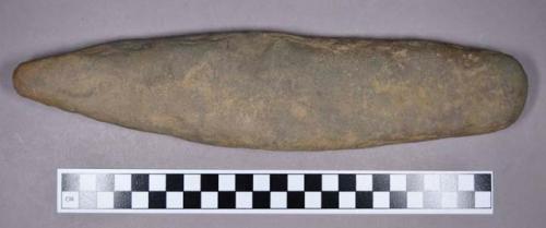 Ground stone, modified lithic, flat on both sides, one end pointed