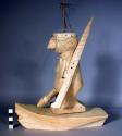 Balsa boat with figure of armed man wearing a crown