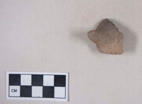 Unpainted potsherd with lug