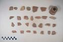 Earthenware vessel sherds with red paint decoration, polchrome decoration. Some rim sherds, body sherds, loop handle fragments, and bottle neck.