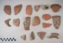 Earthenware vessel sherds with red decoration or polychrome decoration; one with buff body - no paint; some body, some rim, some base, some loop handle, some neck.