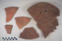 Earthenware vessel sherds; many of red painted plate(s) with ring foot base.