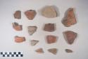 Earthenware vessel sherds; some with red paint exterior, some undecorated; rim, neck, body, and base sherds