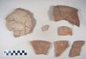Earthenware vessel rim, body, and base sherds with red paint decoration; polychrome decoration on interior  of base sherds.