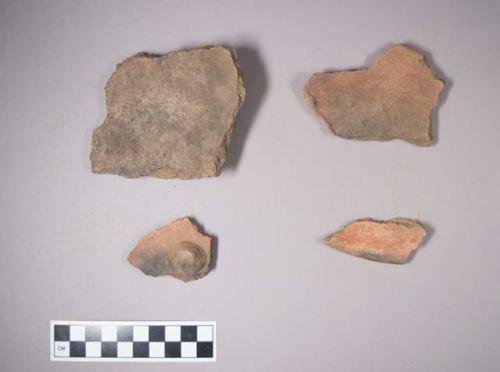 Earthenware vessel body and rim sherds with red paint exterior and interior decoration; some charred; two with nodes.