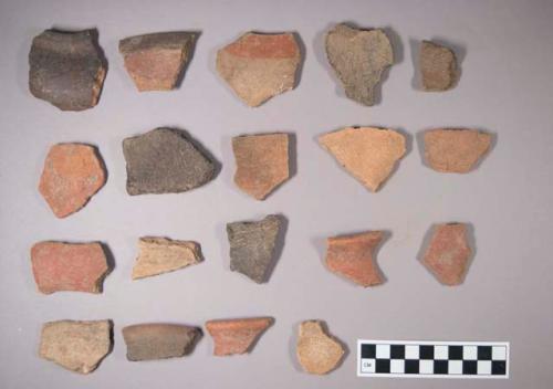 Earthenware vessel sherds some with paint decoration, red, white; Several sherds were charred black.