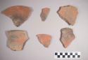 Earthenware vessel sherds with red paint decoration interior and exterior. Some charring.