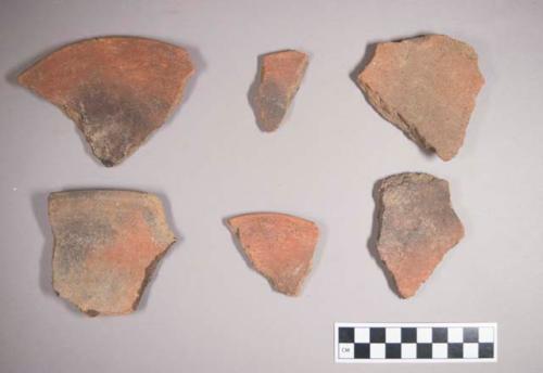 Earthenware vessel sherds with red paint decoration interior and exterior. Some charring.