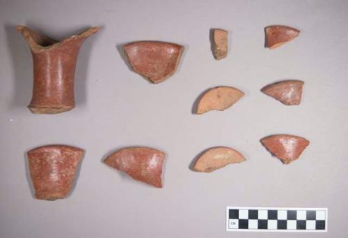 Earthenware vessel sherds with exterior red paint decoration, some with same interior.