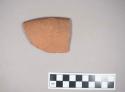 Rim potsherd of red slipped ware with band of red paint around rim