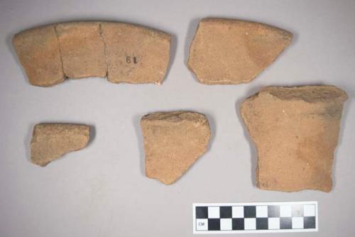 5 rim potsherds of hard gritty, rather thick ware