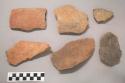 Earthenware vessel rim and body sherds, most with red paint decoration. Some Charred.