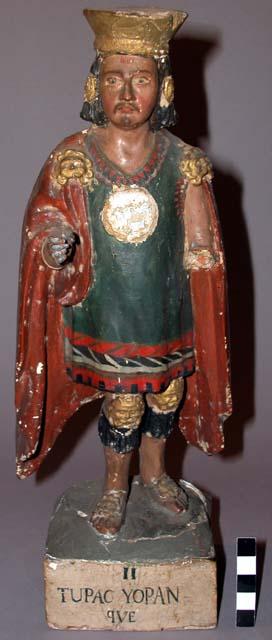 Wood, gesso and polychromed standing figure. unbearded male. one arm and sun emb