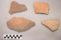 Earthenware vessel body sherds with red paint exterior and charring.