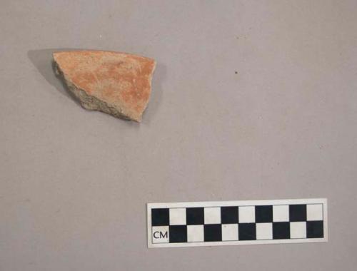 Earthenware vessel rim sherd. Red paint decoration interior and exterior.