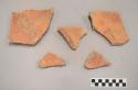 Earthenware vessel rim and body sherds with red paint decoration exterior and interior.