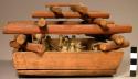 Miniature enclosure of wood with boys carved from bone -- sweat house game