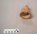 Earthenware vessel rim and carafe neck sherd. Red painted exterior and rim edge. Undecorated interior. Consists of previously crossmended sherds and glued into one object sherd.