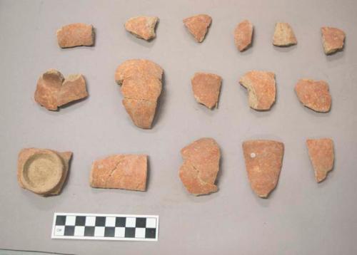 Earthenware vessel rim, body, and  foot ring base sherds, all with red exterior and un decorated interior.