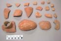 Earthenware vessel rim and body sherds with red painted exterior and rim and undecorated interior. Neck spout sherds.
