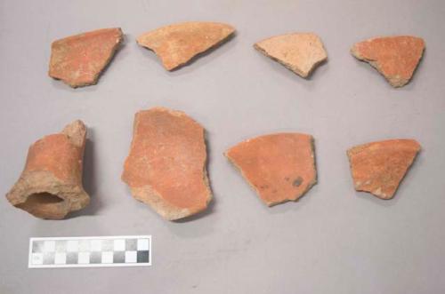 Earthenware vessel sherds and sherds of earthenware pot stands. Red paint decoration.